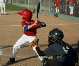 kid hitting baseball